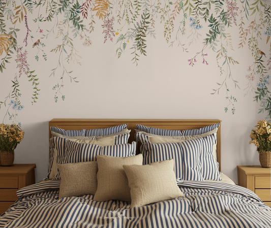 Cottage core striped bed with bedside tables and with a plain white wallpaper with hanging florals.