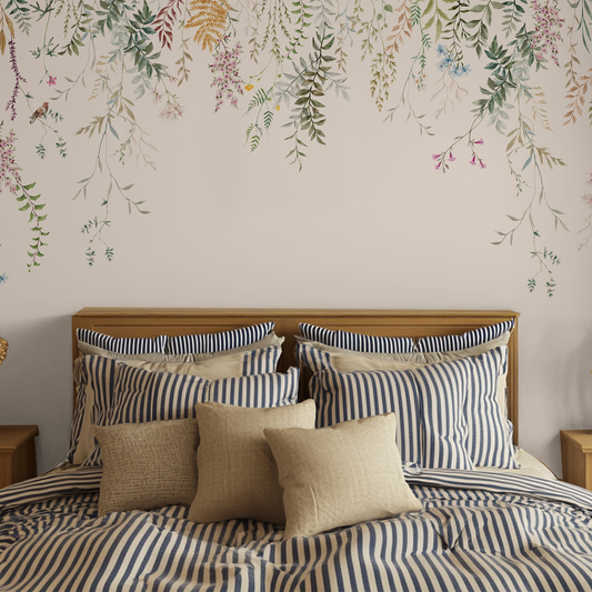 Cottage core striped bed with bedside tables and with a plain white wallpaper with hanging florals.