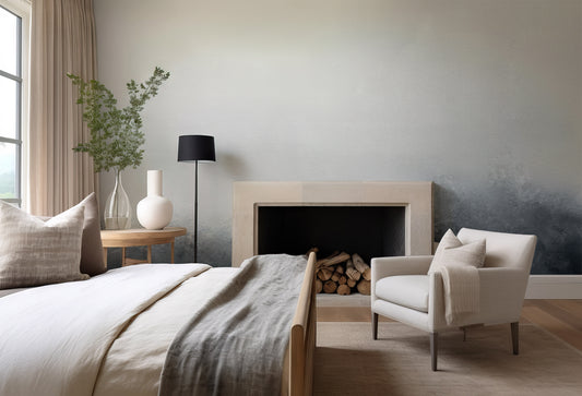 Modern bedroom with bed, chair, and fireplace.