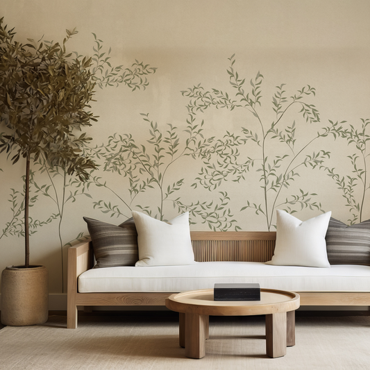 Modern living room with a wooden sofa, decorative pillows, and a wall with leaf patterns.