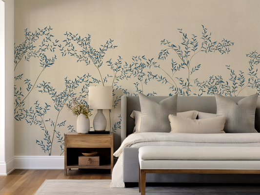 Modern bedroom with floral wall decals and a bed with pillows.