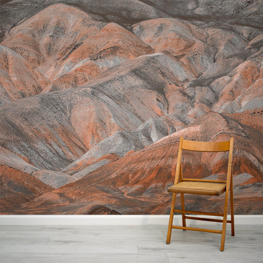 Ridge Wallpaper with a Wooden chair in front of a large wall mural of mountainous landscape