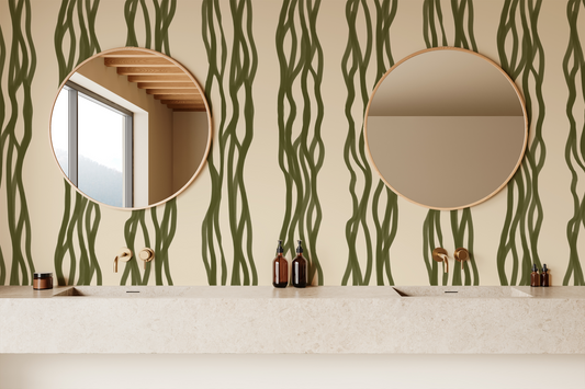 Bathroom with green wavy patterned wallpaper, round mirrors, and bathroom accessories.