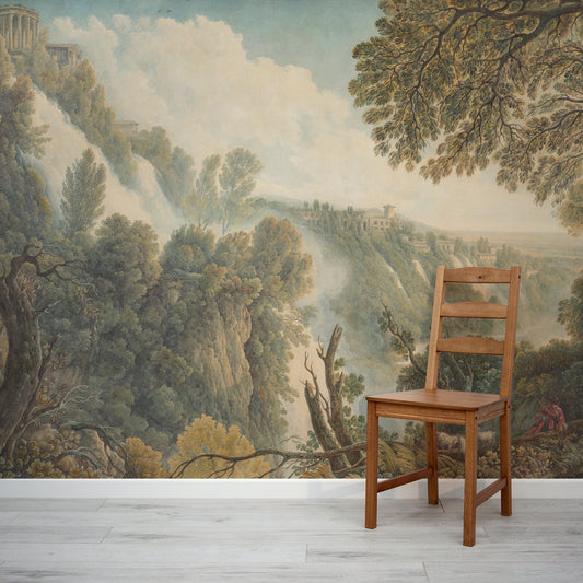 Amalia Wallpaper with a Wooden chair in front of a scenic wall mural with trees and mountains.