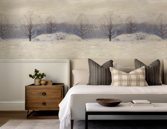 Living room with a sofa, coffee table, and decorative items against a wall with a nature-themed mural.