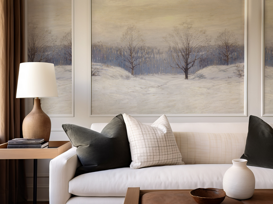 Living room with a white sofa, decorative pillows, a lamp, and wall art.