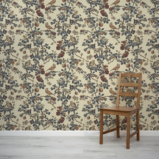Wooden chair in front of a wall with floral and bird patterned wallpaper.