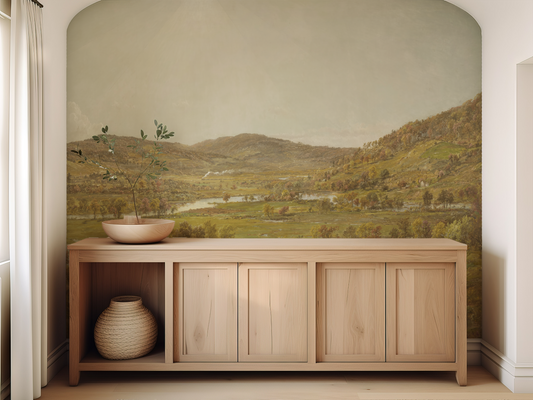 Wooden cabinet with decorative items against a scenic wall mural