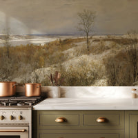 Kitchen with green cabinets, white countertop, and copper pots against a scenic wall mural.