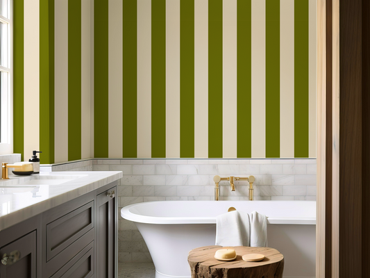 Bathroom with green and beige striped wallpaper, white bathtub, and wooden cabinet.