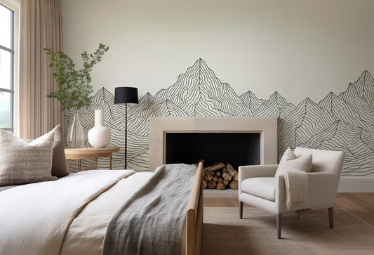 Modern bedroom with mountain wall design, bed, chair, and lamp.
