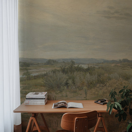 Eowyn Wallpaper with a desk with books and an open magazine in front of a large window with a scenic view.