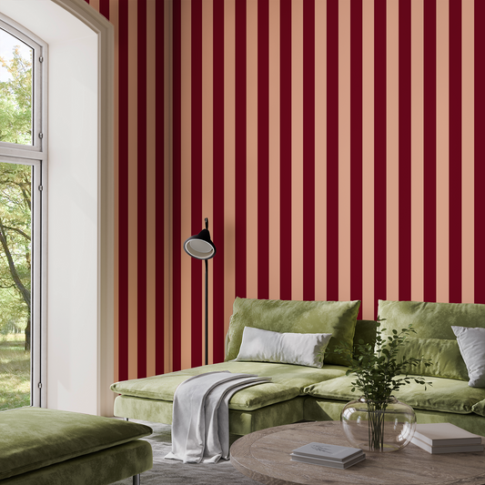 Dark red and light pink striped wallpaper in a living room with a green sofa