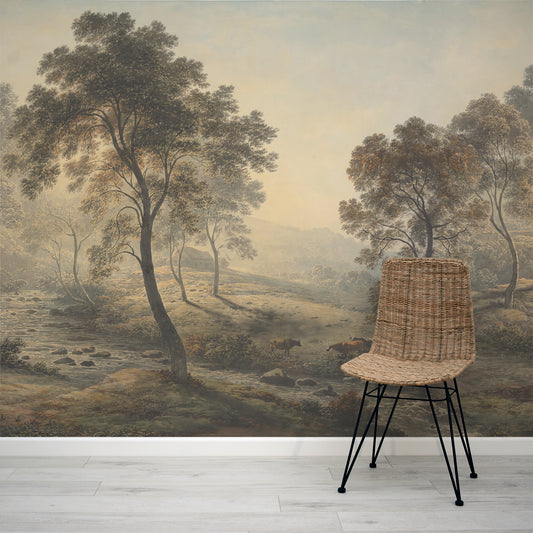 Wicker chair in front of a wall mural depicting a misty landscape with trees and animals.