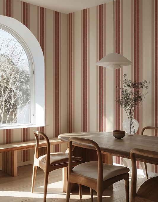 Dining room with striped wallpaper, wooden table, and chairs.