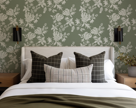 Bedroom with floral wallpaper, white bedspread, and plaid pillows.
