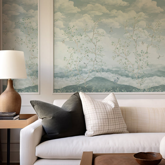 Living room with a white sofa, decorative pillows, and framed artwork on the wall.