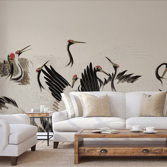 A large wall mural featuring black and white cranes with red heads, displayed behind a white sofa in a modern living room setting.