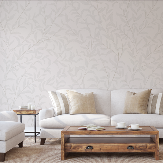 Living room with white sofa, wooden coffee table, and patterned wallpaper