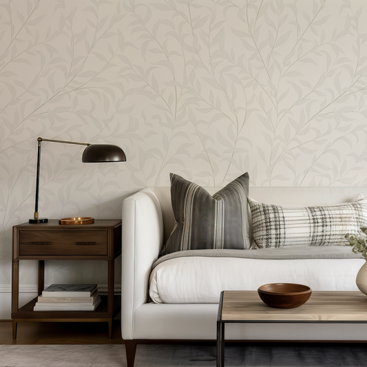 Living room with a white sofa, wooden side table, and decorative items.