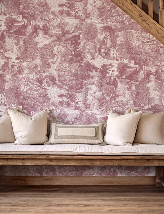 Pink toile wallpaper with a wooden bench and white cushions in a room.
