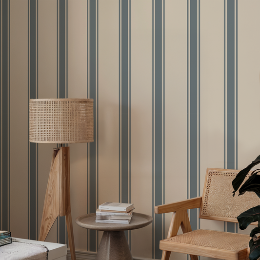 Living room with striped wallpaper, wooden lamp, table, and chair.