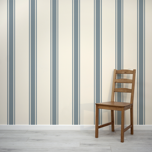 Wooden chair against a wall with vertical striped pattern
