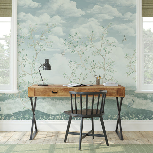 Wooden desk with chair against a decorative wall with nature-themed wallpaper