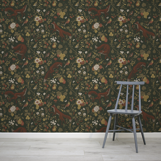 Chair in front of a wall with intricate floral and fox wallpaper design.
