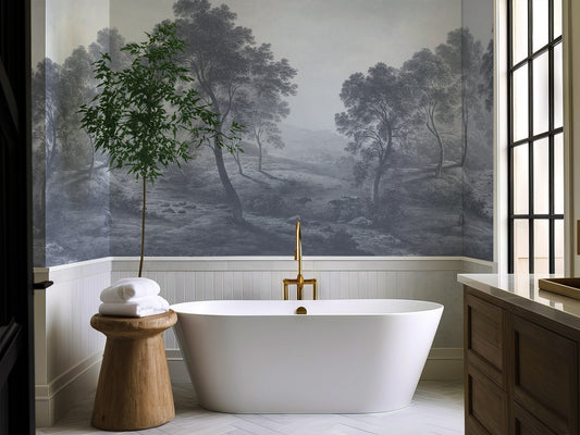 Modern bathroom with freestanding bathtub, wooden stool, and wall mural of a forest.