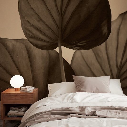 Bedroom with a large leaf mural and a nightstand with a lamp.