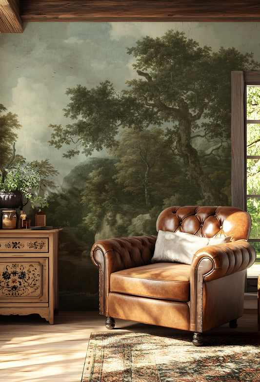 Sylvia Wallpaper with a Brown leather armchair in a room with a forest mural on the wall.