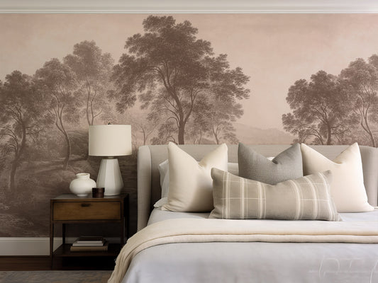 Bedroom with a mural of trees on the wall, featuring a bed with pillows and a lamp.