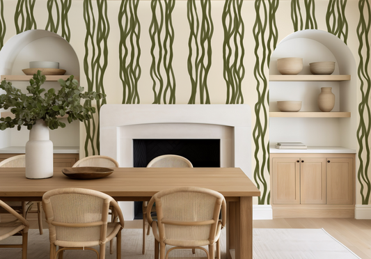 Dining room with wooden table, chairs, and shelves against a wall with green wavy patterns.