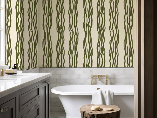 Bathroom with green wavy patterned wallpaper, white bathtub, and wooden cabinet.