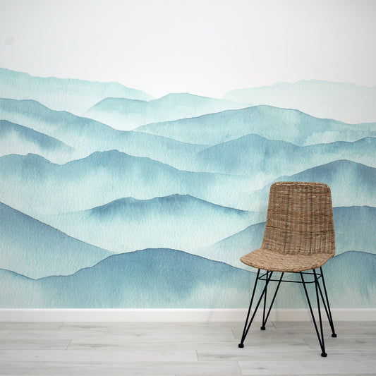 Blue Watercolour Mountains Painting Wallpaper Mural Interior Design with a Rattan Chair