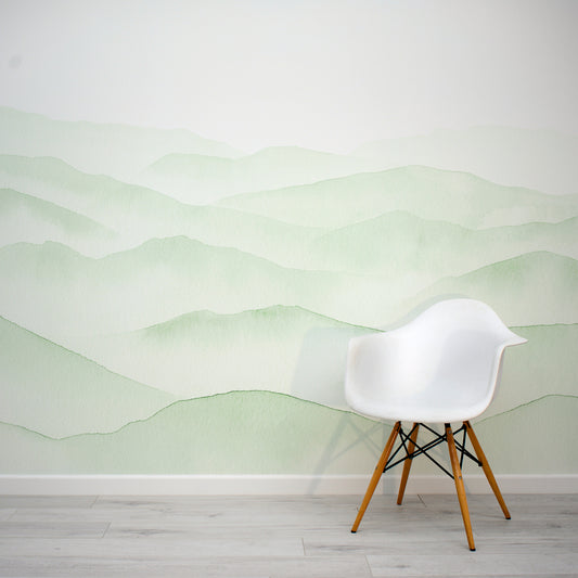 Fjelle Sage Green Watercolour Mountains Painting Wallpaper Mural Interior Design with a White Eames Chair